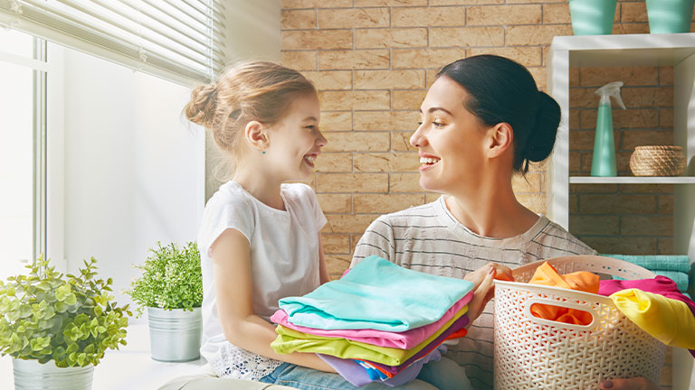 woman and child doing laundry